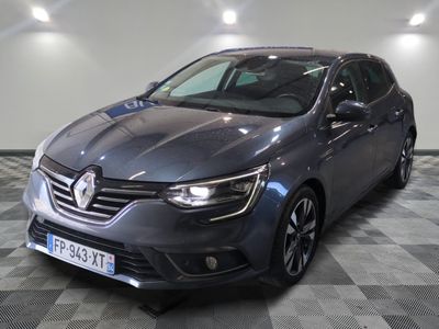 the grey car is parked on a checkered floor in a garage