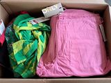 a cardboard box filled with clothes and a tag on it