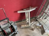 a machine that is sitting on the floor next to a red wall
