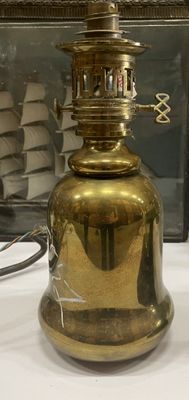 a gold lamp that is sitting on a white table