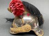a helmet with a red flower on top of it