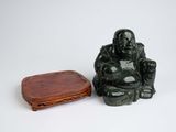 a small statue of a buddha sitting next to a small wooden box