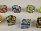 several different types of decorative boxes are arranged on a white surface
