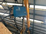 an overhead view of a crane in a building with a sky background