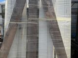 a large pile of wooden boards stacked on top of each other