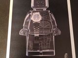 framed black and white photograph of a lego man with a clock on his face