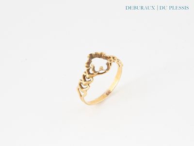 gros plan d'une bague en or sur une surface blanche