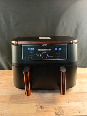 an image of a coffee maker on a wooden table