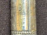 a small silver object on a black cloth