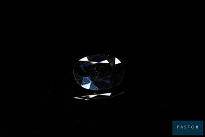 a close up of a blue diamond on a black background