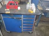 a blue workbench with tools on it in a garage