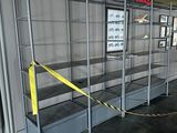 a display case in the middle of a room with a yellow ribbon