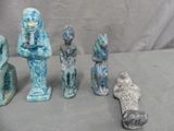 several statues of different sizes and shapes are sitting on a table