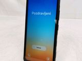 a close up of the back of a black phone with a blue screen