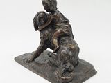 bronze statue of a boy and a dog on a stone base