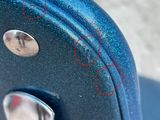 a close up of a piece of luggage with red marks on it