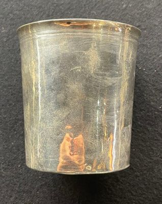 a silver cup with a picture of a man and a woman on it