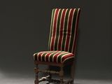 a chair that has a striped seat and a wooden frame