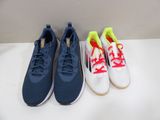 three pairs of running shoes are lined up on a table