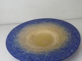a blue and yellow plate on a white table