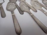 a lot of silver spoons and forks on a table