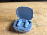 a close up of a pair of blue ear buds in a blue case