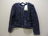 a close up of a sweater on a hanger on a wall