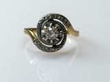 a close up of a ring with a diamond in it