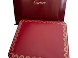 red gift box with a red handle and a red bag with a name on it