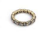 a close up of a gold and black diamond ring on a white background