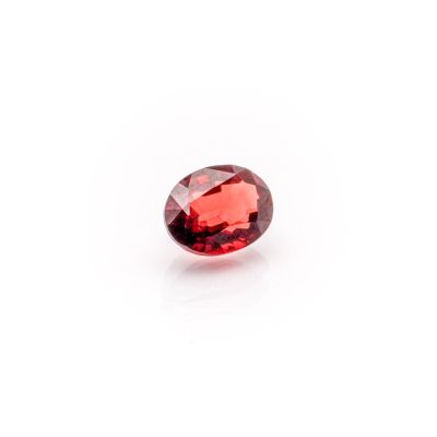 a red garnet stone on a white background