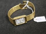 an image of a gold wrist watch with a price tag on it