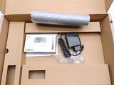 a box with a cell phone and a charger inside of it