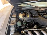 a car with its hood open and the engine in the back