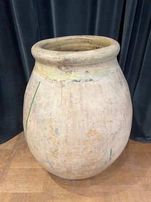a large stone pot sitting on a wooden table