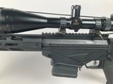 a close up of a rifle with a scope on a white background