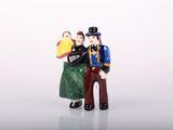 a figurine of a man and a woman holding a book