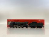 an image of a toy train on a white surface with a red box in the background