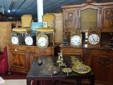 a room with a lot of furniture and clocks on it