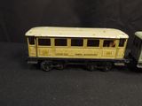 two toy trains sitting side by side on a black background