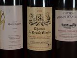 several bottles of wine are lined up on a shelf