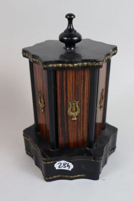 a small wooden box with a lid on a white surface