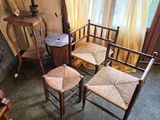 four chairs and a table in the corner of a room