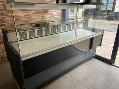 a glass display case in the middle of a room