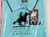 two polo shirts are wrapped in plastic bags on a table