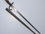 an old pair of swords on a white surface