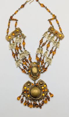 a close up of a necklace on a white surface