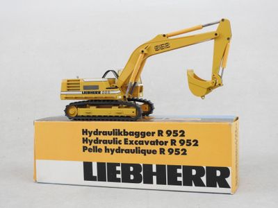 a yellow toy excavator sitting on top of a box