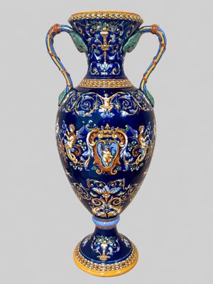 a large blue vase with a gold decoration on it