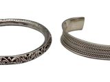 two silver bracelets on a white background with a white background